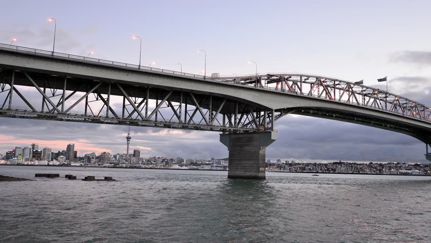 Timelapse of Auckland harbor bridge at sunset.