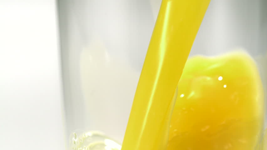Pouring orange juice into glass shooting with high speed camera.