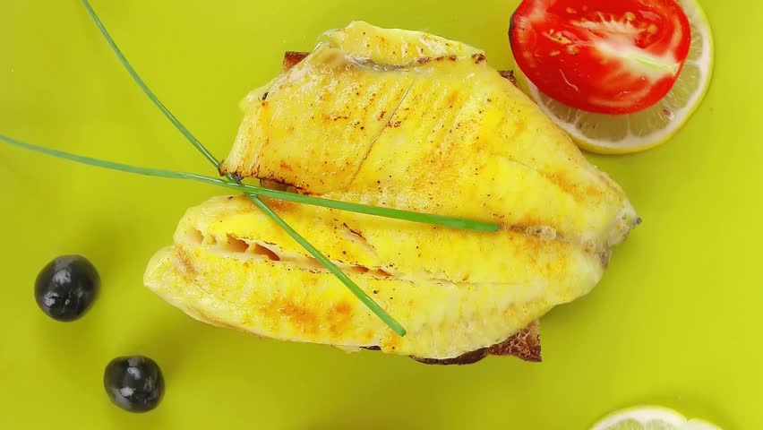 savory: fish fillet with tomatoes,chives and lemon on plate