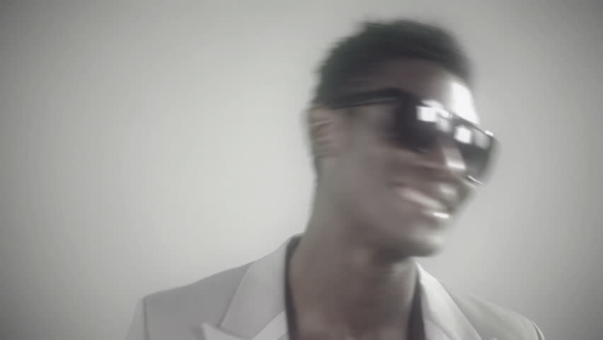 young african guy waving and dancing with a cool attitude and laughing
