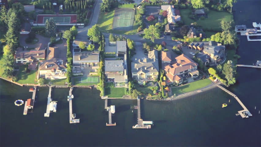 Overhead right pan across luxurious estates, yards and yachts on lakefront property
