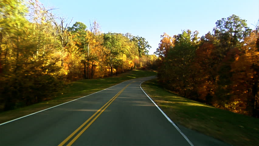 POV of driving down a quiet rural highway during the day in autumn 1080 HD video
