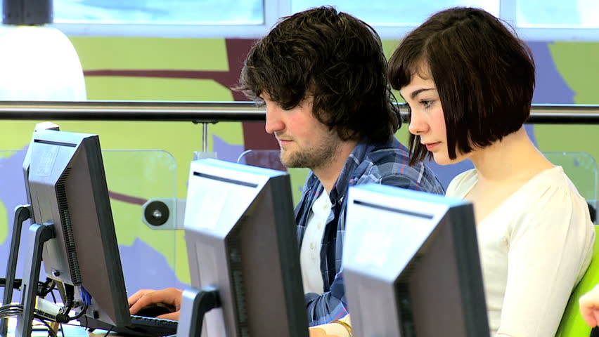 Group of male and female Caucasian university colleague e-learning new IT technology method on computer