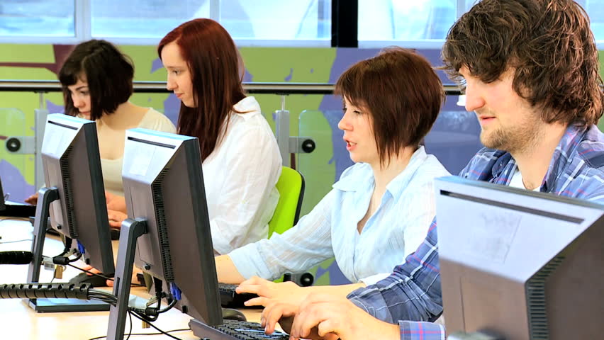 University Caucasian friends e-learning in modern classroom on computers