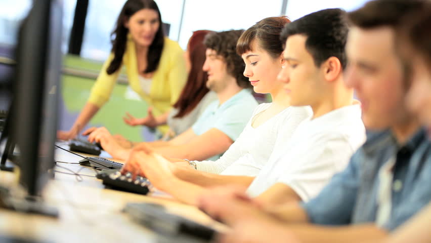Group of diverse male and female students focus on university project instruction Caucasian female teacher in IT information hub