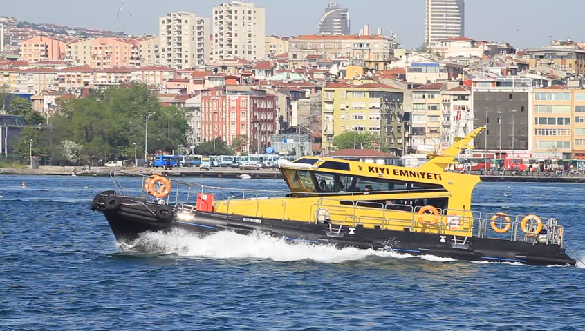 ISTANBUL - APRIL 28: Coast guard boat KIYI EMNIYETI maneuvering in front of docks on April 28, 2012 in Istanbul. An escort board is compulsory in straits for all the tankers over 249,99 meters 
