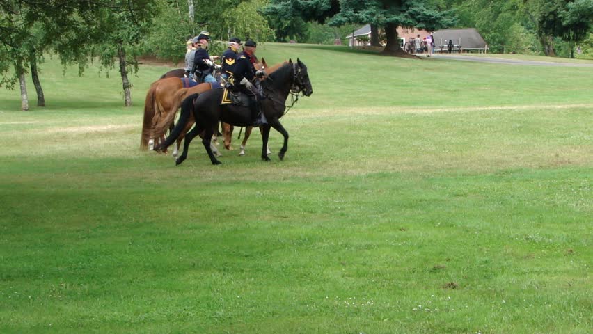 PORT GAMBLE, WA - JUN 20:  	Union and Confederate cavalry ride through trees and across field in a mock battle at Port Gamble WA on June 20, 2009.
