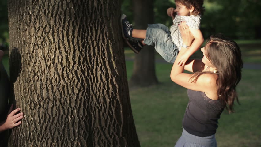Young happy family playing in the park, crane shot