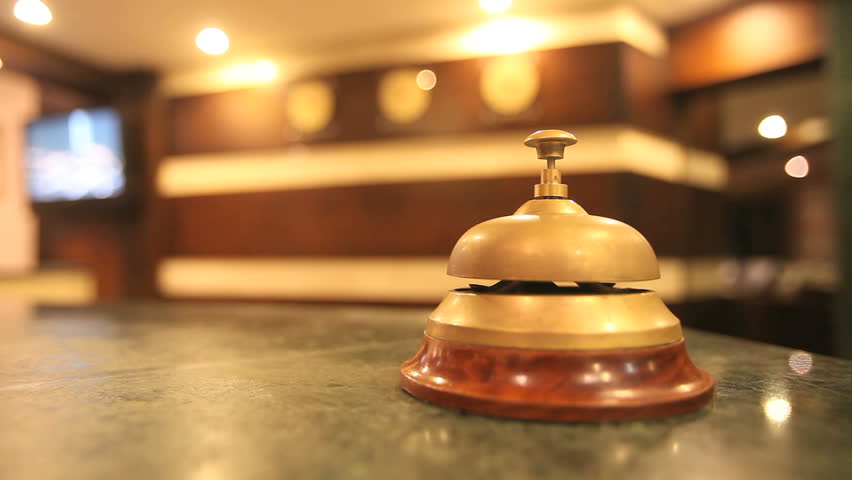 call on a old hotel bell on a wood stand
