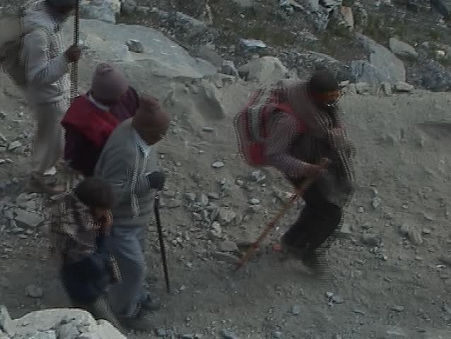 Exhausted and injured pilgrim assisted by his friends