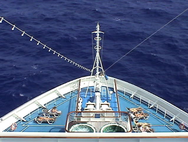 Video of the front bow of a cruise ship with girl sunbathers and hot tubs.