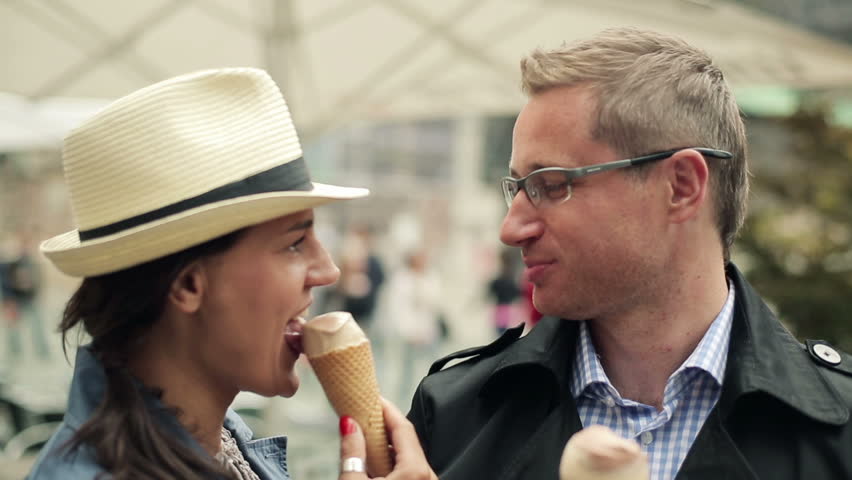 Young tourist couple enjoying an ice cream treat at the vacation
