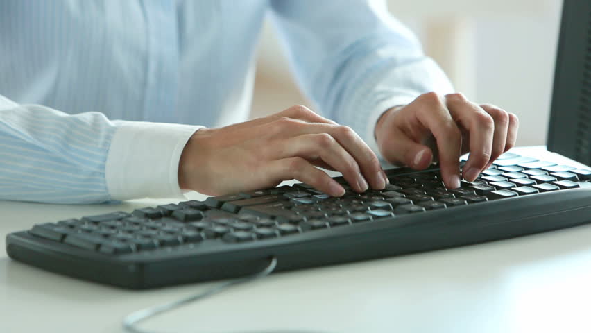 Close-up of a female office worker inputting business data