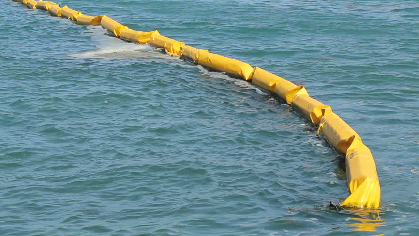 Oil slick contention barrier during environmental emergency.