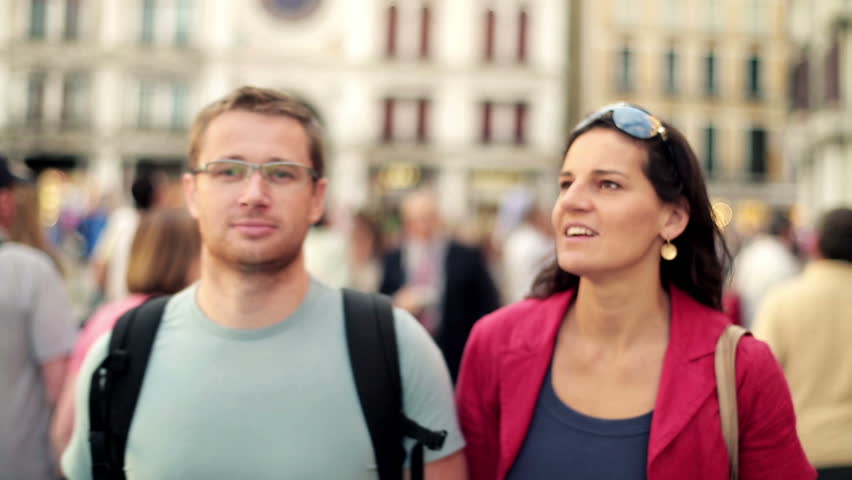 Young couple walking together in the old town, steadycam shot
