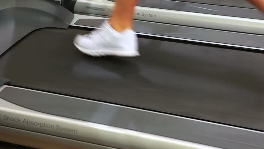 Feet running on treadmill in gym