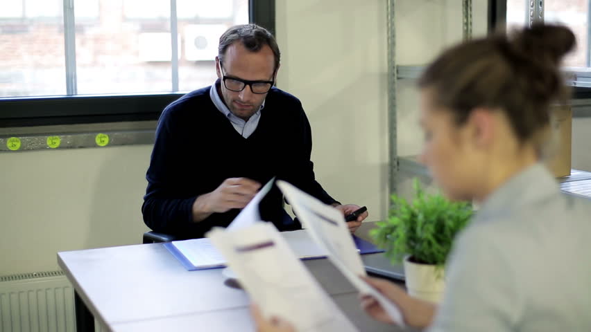 Overworked businessman looking in documents in office
