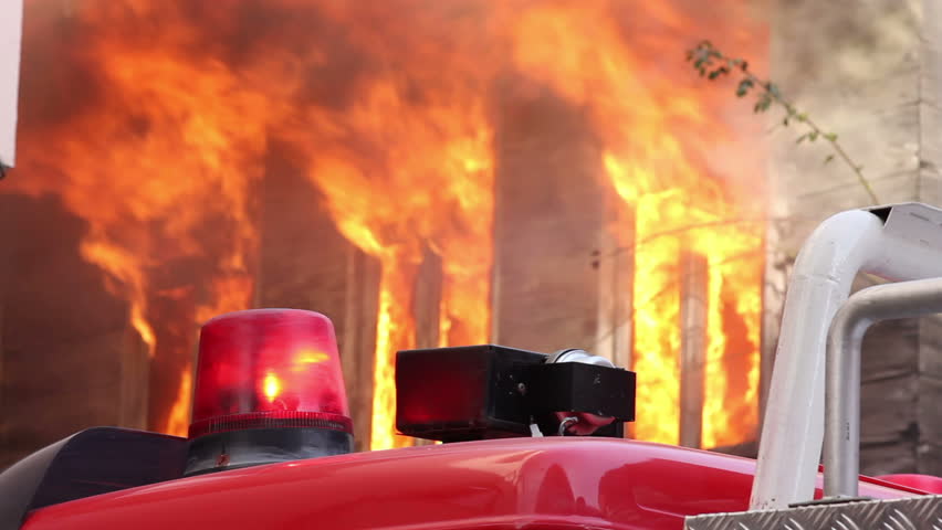 fire billowing inside a wooden house