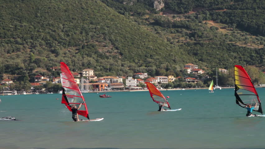 VASSILIKI, LEFKAS ISLAND/GREECE - OCTOBER 5: Windsurfers catch the wind in Vassiliki Bay on October 5, 2012 in Vassiliki. The bay is famous for sailing because of reliable mountain winds