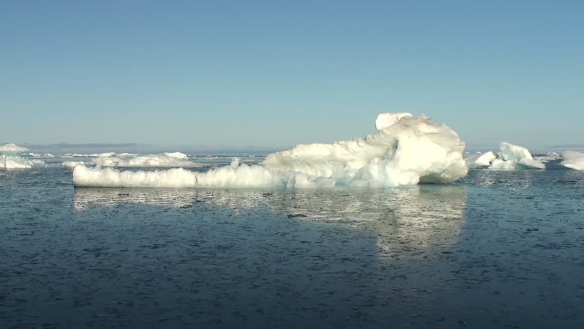 Ice field in the Canadian High Arctic at sunrise. Calm and cloudless day in a dinghy, glassy sea with very nice reflections. Realtime. Smooth. 