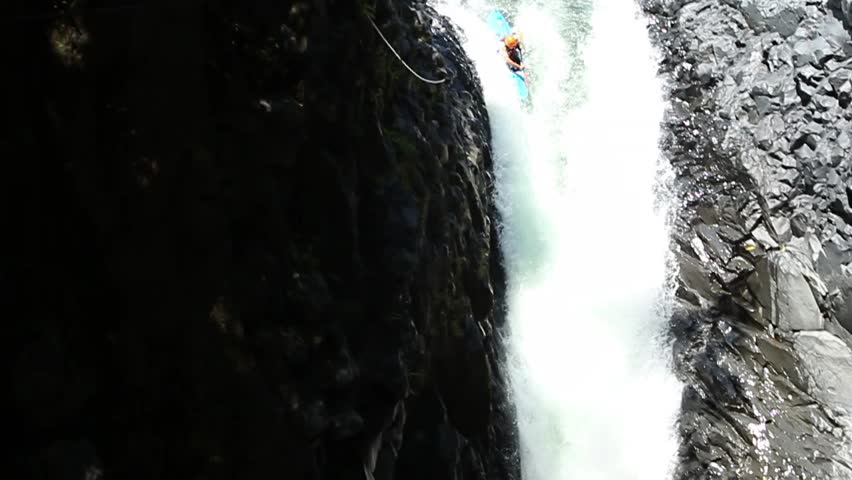 Duende waterfall jump in kayak in Ecuadorian rain forest. HD slow motion.