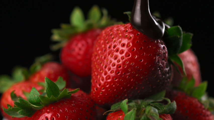 Chocolate sauce on strawberry shooting with high speed camera.