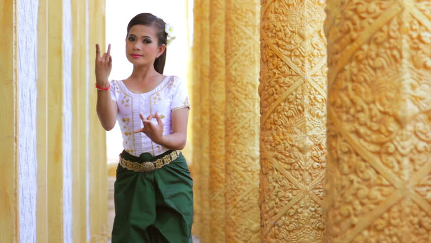 Beautiful Asian female performs Cambodian folk dance in temple