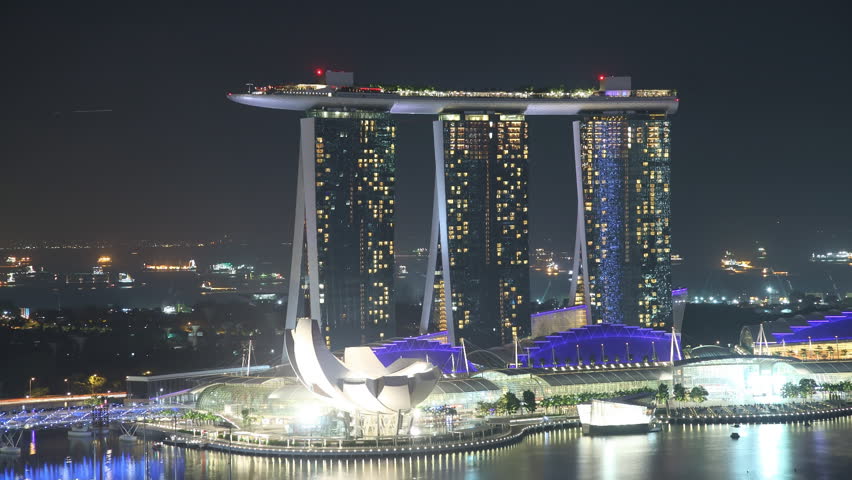 EL: Marina â Singapore January 9 2012: Time Lapse Singapore at Night. View to Marina Sands Resort in Singapore on January 9 2012