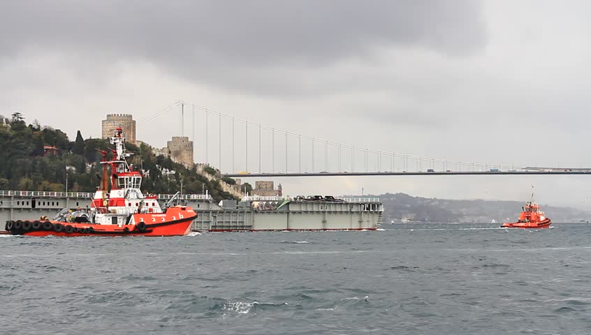 ISTANBUL - OCT 20: Towing Operation in Bosporus Sea on October 20, 2012 in Istanbul. Some 50,000 ships pass through the Turkish Straits every year. Towing a large vessel platform
