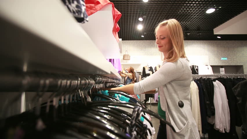Beautiful blonde girl enjoying her favorite hobby - shopping