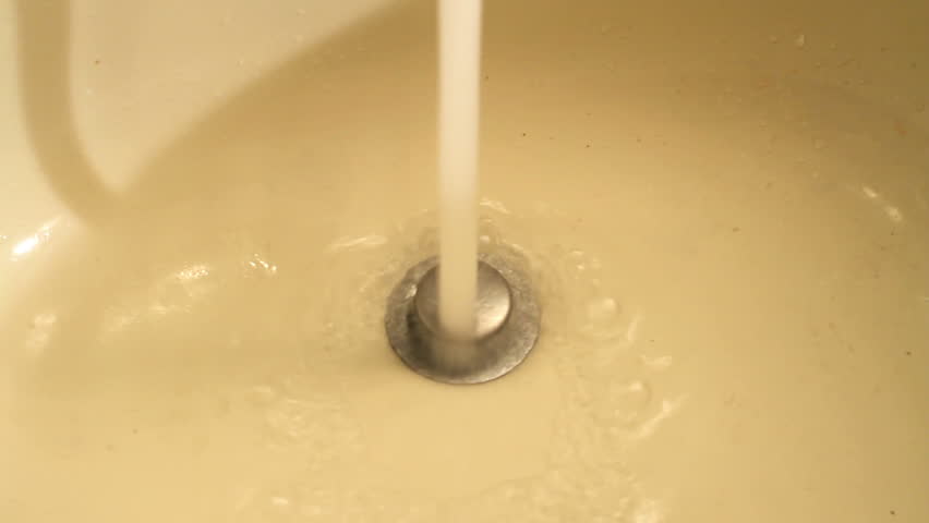 Spitting blood into sink  