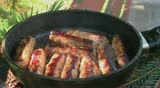 Sausages in a frying pan, cooked, ready to eat at home, outdoor or at a restaurant.