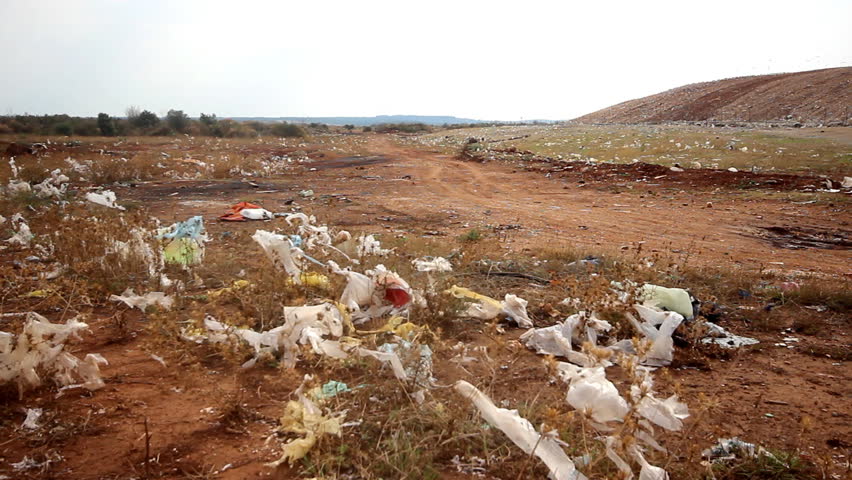 Smelly landfill

Description: Nylon bags on the field with garabage trucks passing

