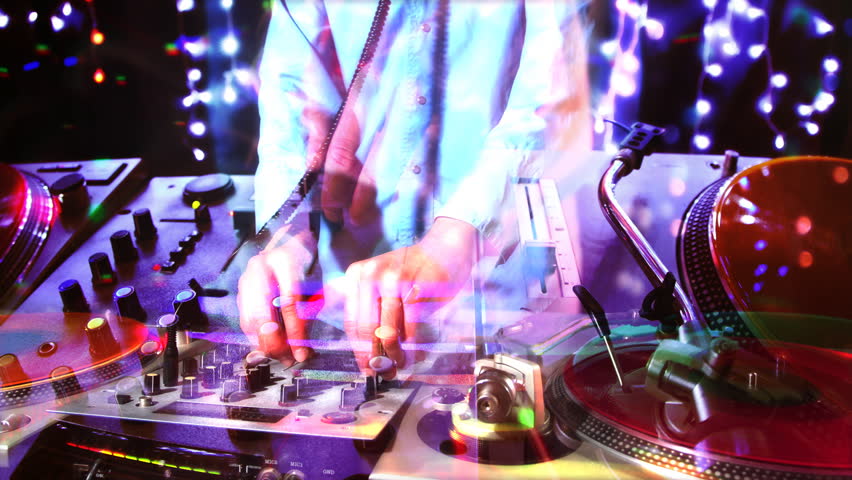 studio shoot of a cool male dj behind the turntables