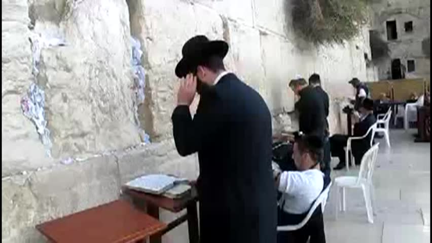 JERUSALEM -  CIRCA OCTOBER 2011: Jewish men pray at the Western wall circa October 2011 in Jerusalem, Israel. The wall is one of the holiest sites in Judaism attracting thousands of worshipers daily. 