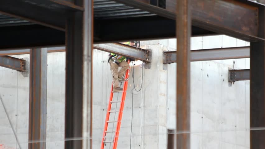 Welder On A Ladder At Work On A Building Site