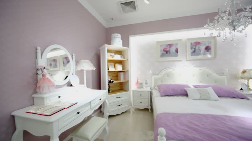 Females bedroom with many furniture and pink color wallpapers, shown in motion