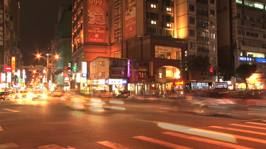 TAIPEI, TAIWAN - CIRCA 2012: Taipei crossing downtown with cars and scooters traffic