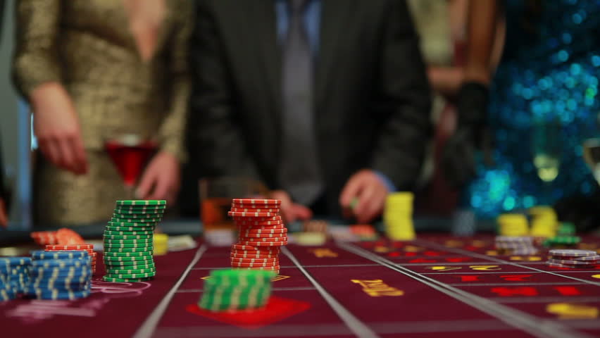 People placing their bets on the roulette table in the casino
