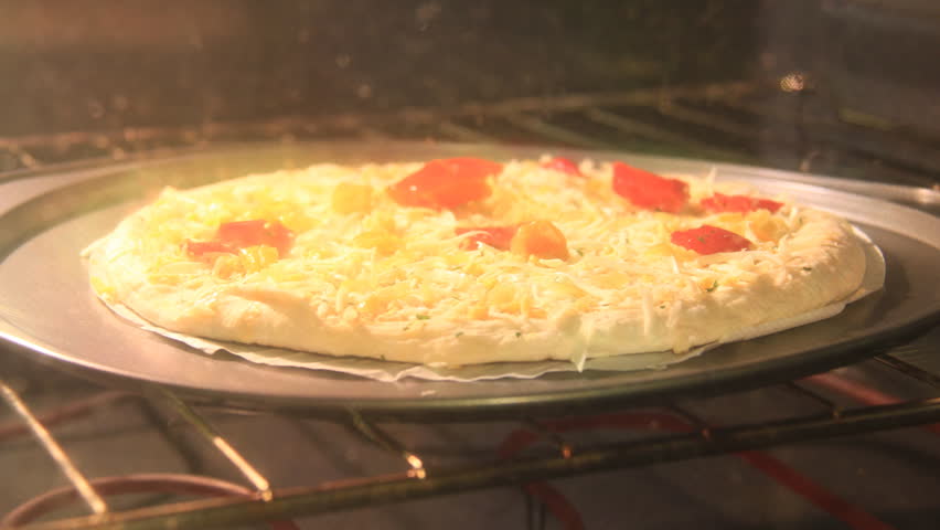 Pizza Bubble Timelapse. Small pizza in an electric home oven being cooked. Shot in time-lapse.