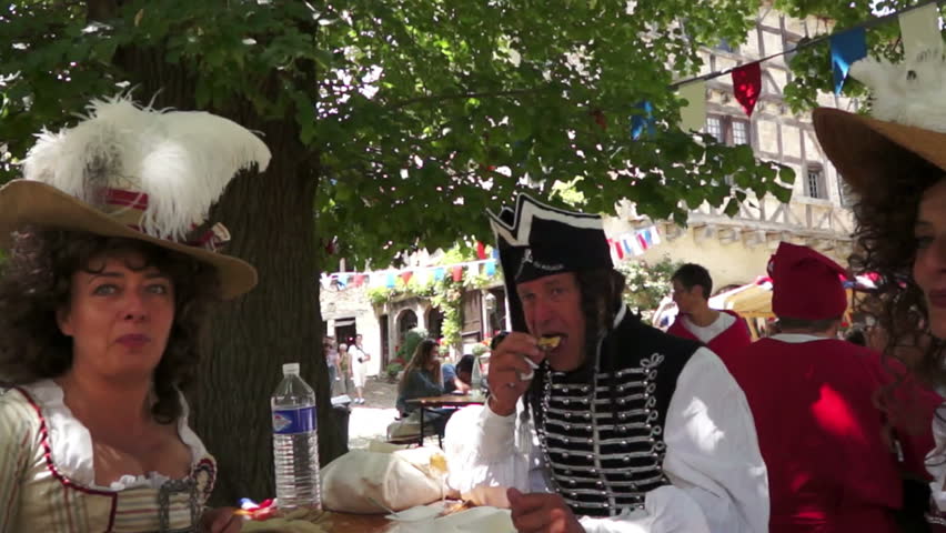 PEROUGES, FRANCE - JULY 14: People commemorate the French Revolution on July 14, 2012 in Perouges, France in an annual celebration by wearing historical costume and singing the popular songs of their ancestors.