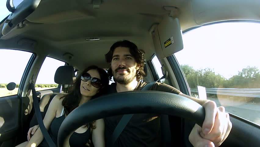 Romantic couple in car looks at scenery