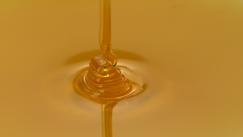 Honey pouring on honey comb shooting with high speed camera.
