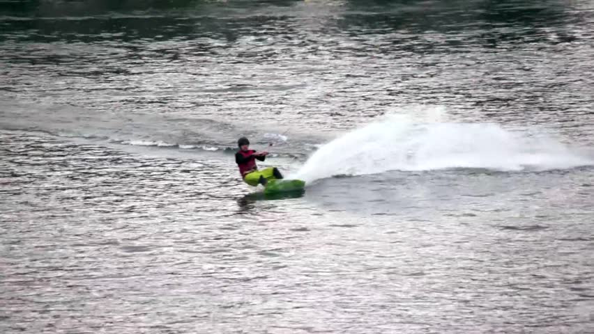 A wakeboarder performs a series of jumps.
