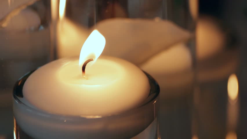 Close up of a candle on a table.