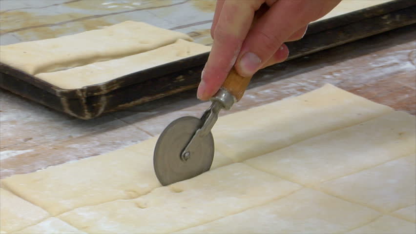 Baker cuts pieces of dough with a rotary cutter. You will find even more GERMAN BAKERY clips in my portfolio!
