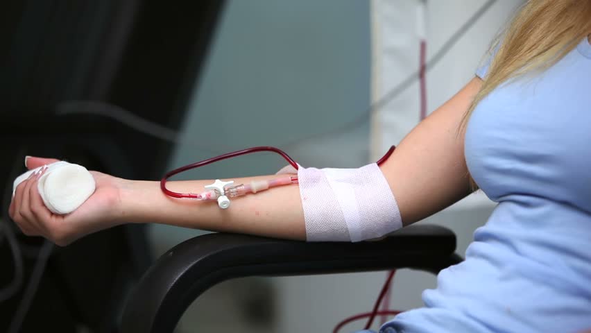 Patient receiving a transfusion in hospital ward