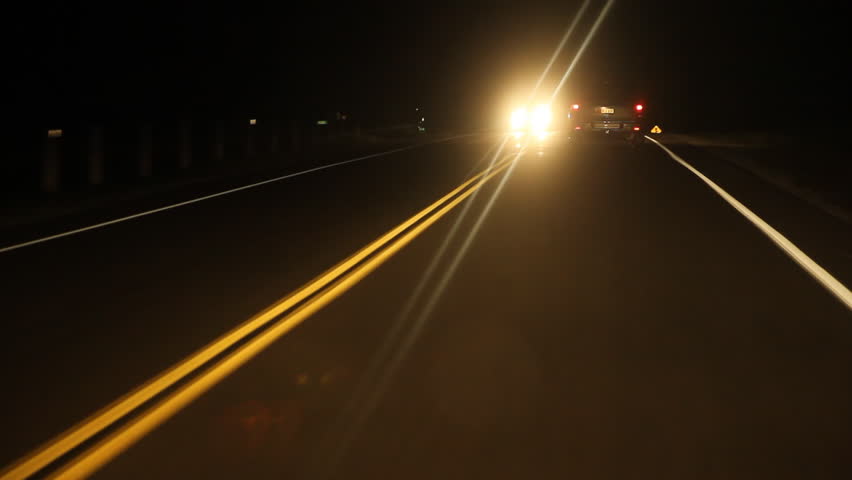 Night drive with approaching car.
Driving at night on a rural road. Ontario, Canada.

