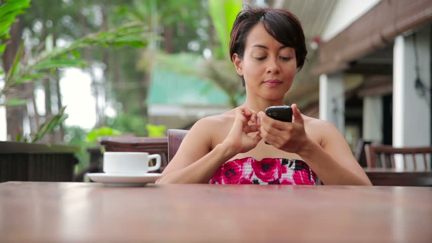 Freelance business woman working at cafe on her smartphone