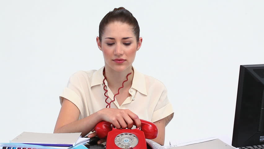 Overworked businesswoman picking up two phones against white background